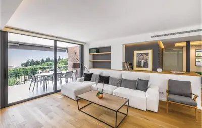 a living room with a white couch and a table at Stunning Home In Alella With Wifi in Alella