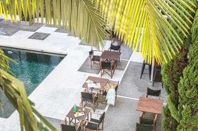 an overhead view of a patio with tables and chairs next to a pool at Hotel Medium Sitges Park in Sitges