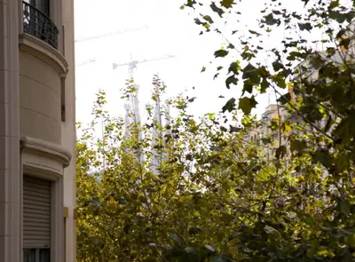 a cross on top of a building next to a tree at Avinguda Gaudi Apartment in Barcelona