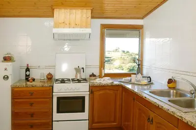 a kitchen with a white stove top oven next to a sink at Agroturisme Cal Jeroni in Avinyonet