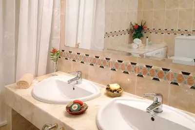 a bathroom with two sinks and a mirror at Agroturisme Cal Jeroni in Avinyonet
