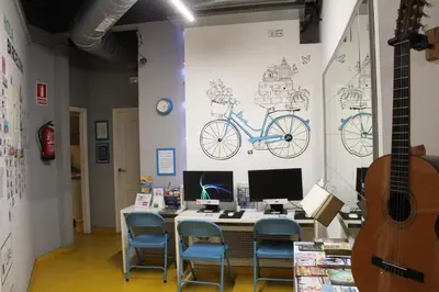 a room with a desk with a blue bike on the wall at Sleep Green - Certified Eco Youth Hostel in Barcelona