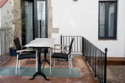 a table and two chairs on a balcony at Sa Voga Hotel & Spa in Arenys de Mar