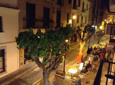 a view of a street at night with a tree at Sa Voga Hotel & Spa in Arenys de Mar