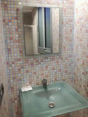 a bathroom with a green sink and a mirror at Pensión San Ramón in Barcelona