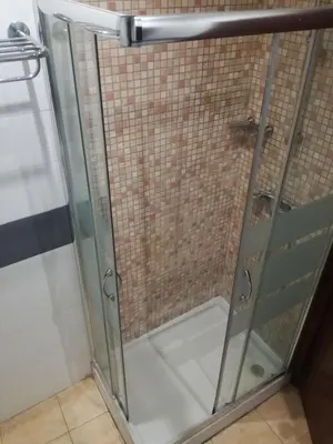 a shower with a glass door in a bathroom at Pensión San Ramón in Barcelona