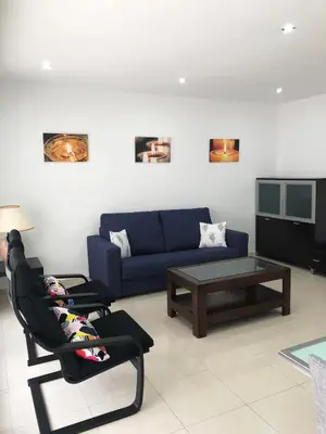 a living room with a blue couch and a coffee table at Apartamento Montroig 1 in Sitges