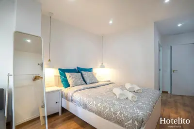a bedroom with a bed with two towels on it at Hotelito Boutique Mercat in Hospitalet de Llobregat