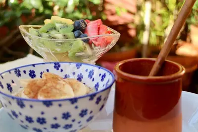 a blue and white bowl of food and a cup of sauce at Hostal Poblenou in Barcelona