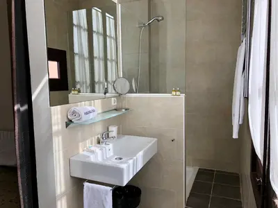 a bathroom with a white sink and a mirror at Hostal Poblenou in Barcelona