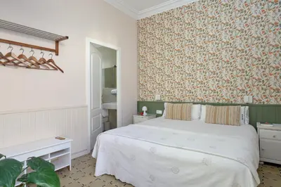 a bedroom with a bed and a floral wallpaper at Hostal Poblenou in Barcelona
