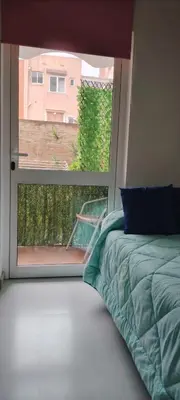 a bedroom with a bed and a large window at Estudio con balcon Plaza España in Barcelona