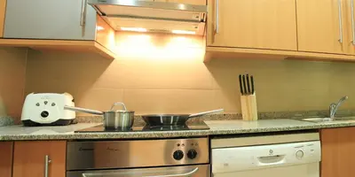 a kitchen with a stove with two pots on it at Alguera Apartments Industria in Barcelona