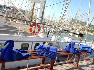 a boat with blue bags sitting on the deck at Southern Cross in Barcelona