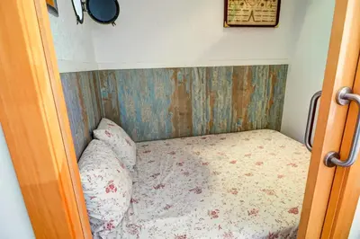 a small bed in a small room with at Aquarium Apartment by Hello Homes Sitges in Sitges