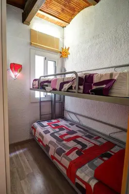 a bunk bed in a dorm room with a bed sidx sidx sidx at Aquarium Apartment by Hello Homes Sitges in Sitges