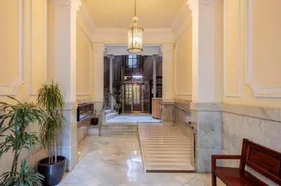 a hallway of a building with a potted plant at The Gaudi Suites in Barcelona