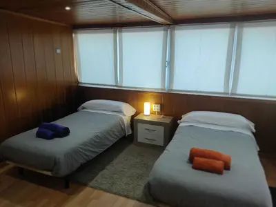 two beds in a small room with windows at PISO EXTERIOR COMPLETO A 20 ' DE BARCELONA. in Sabadell