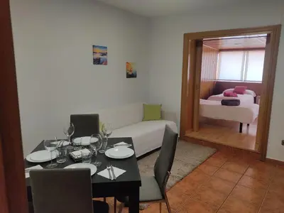 a living room with a table and a couch at PISO EXTERIOR COMPLETO A 20 ' DE BARCELONA. in Sabadell