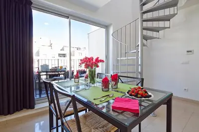 a dining room with a table with flowers on it at Charmsuites Paralel in Barcelona