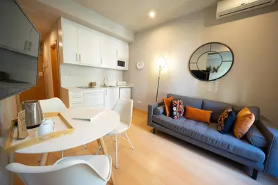a living room with a blue couch and a table at Bonavista Apartments - Eixample in Barcelona