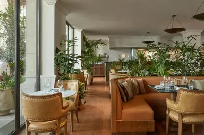 a restaurant with a couch and tables and chairs at Miiro Borneta in Barcelona