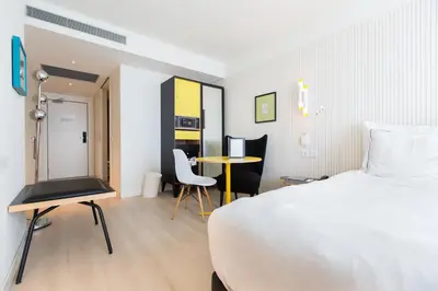 a hotel room with a bed and a table and chairs at Vincci Bit in Barcelona