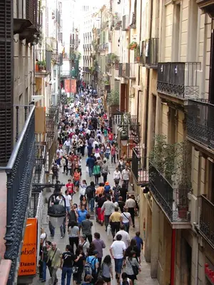 a crowd of people walking down a city street at Hostal Fina in Barcelona