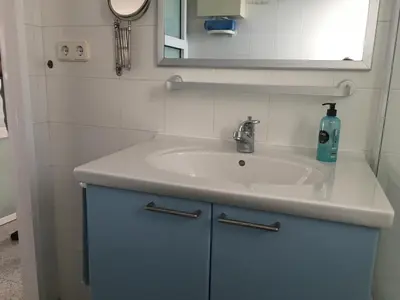 a bathroom sink with a bottle of soap on it at Solimar in Castelldefels