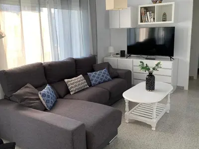 a living room with a couch and a tv at Solimar in Castelldefels