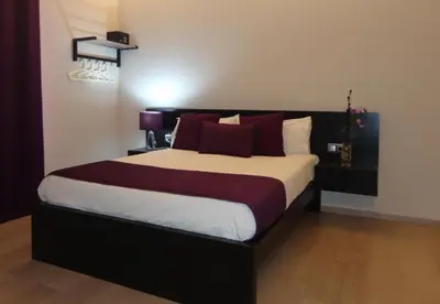 a bedroom with a large bed with red pillows at BruStar Gotic-Centric in Barcelona
