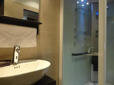 a bathroom with a sink and a glass shower at BruStar Gotic-Centric in Barcelona