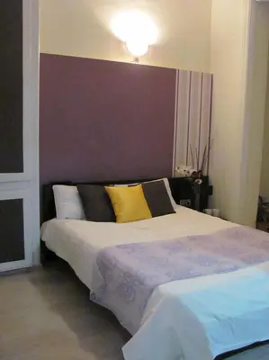 a bedroom with a large bed with yellow and black pillows at BruStar Gotic-Centric in Barcelona