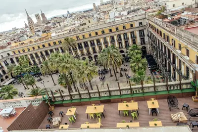an overhead view of a building with tables and palm trees at Kabul Party Hostel Barcelona in Barcelona