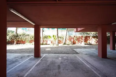 an empty room with red columns in a building at Calm, Beach and Bikes in Castelldefels