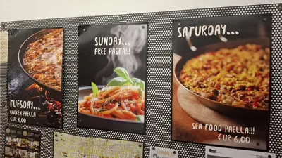 a display of three signs with different food dishes at Mediterranean Hostel Barcelona in Barcelona