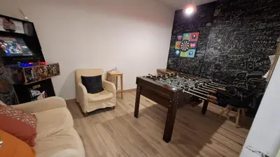 a living room with a large organ in front of a wall at Mediterranean Hostel Barcelona in Barcelona
