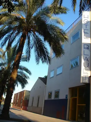 a palm tree in front of a building at Hotel Blauet by Bossh! Hotels in El Prat de Llobregat