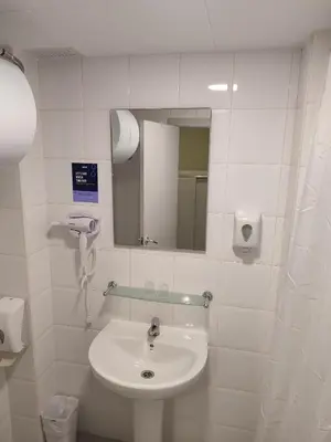 a white bathroom with a sink and a mirror at Hotel Blauet by Bossh! Hotels in El Prat de Llobregat