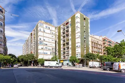 a tall building with cars parked in front of it at Sweett - Eixample Borrell in Barcelona