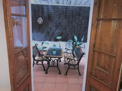a patio with a table and chairs in a room at Top Barcelona Apartments in Barcelona
