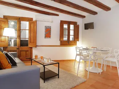 a living room with a couch and a table at Top Barcelona Apartments in Barcelona