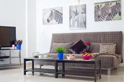 a living room with a couch and a coffee table at Charmsuites Nou Rambla in Barcelona