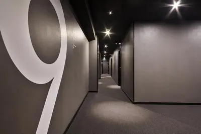 a hallway with black walls and a row of doors at Andante Hotel in Barcelona