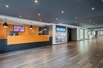 a lobby with a reception desk and wooden floors at Andante Hotel in Barcelona