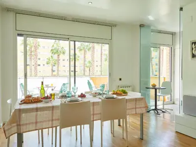 a dining room with a table and chairs at BarcelonaForRent Vila Olimpica Pool Suites in Barcelona