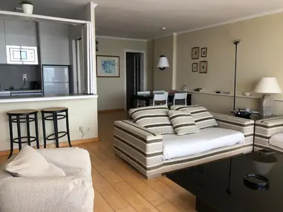 a living room with a couch and a table at Llevant - Vistas espectaculares in San Pol de Mar
