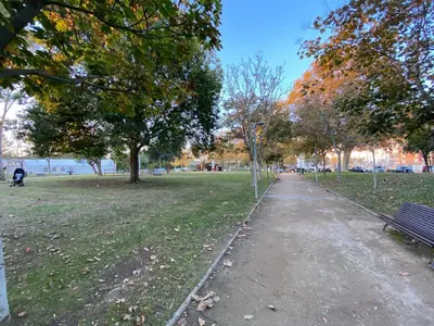 a park with a bench and trees and a path at Llevant - Vistas espectaculares in San Pol de Mar