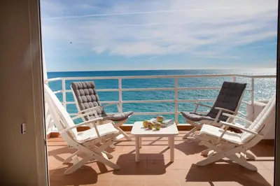 two chairs and a table on a balcony with the ocean at Ponent - Espectaculares vistas al mar in San Pol de Mar