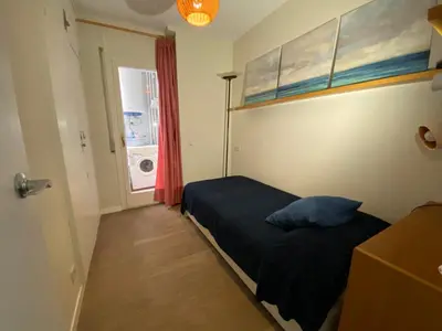 a small bedroom with a bed and a window at Ponent - Espectaculares vistas al mar in San Pol de Mar